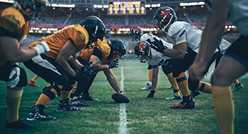 football players set up for a play on the field